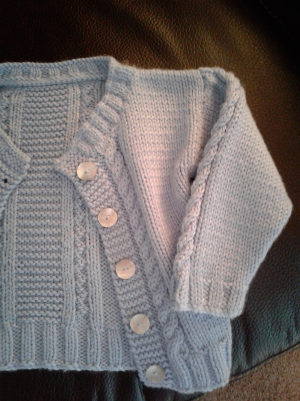 Baby blue cardigan with mother-of-pearl buttons.