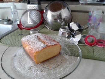 Lemon yogurt cake in front of moka espresso pot and dishes